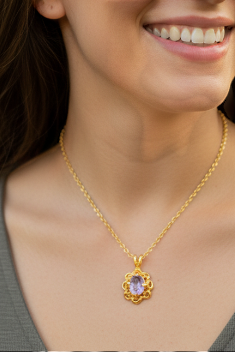 Heartfelt Creations gold-plated necklace with an intricate floral pendant and a central oval purple gemstone