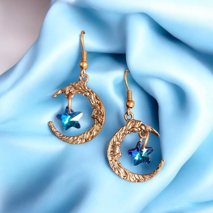 Heartfelt Creations celestial drop earrings featuring textured gold-tone crescent moons and blue crystal star charms.