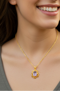 Heartfelt Creations gold plated pendant necklace with intricate floral detailing and a pink gemstone.