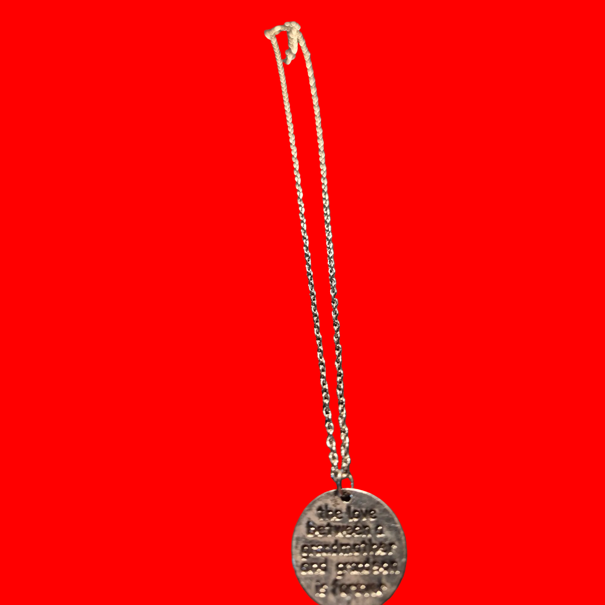 Heartfelt Creations silver-toned metal pendant necklace engraved with 'the love between a grandmother and grandson is forever'.