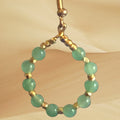 Heartfelt Creations handcrafted hoop earrings featuring smooth green gemstone beads and gold-tone metallic spacers.