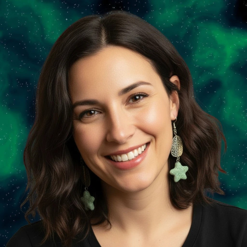 Heartfelt Creations textured light green star drop earrings with hammered silver oval accents worn by a smiling woman.