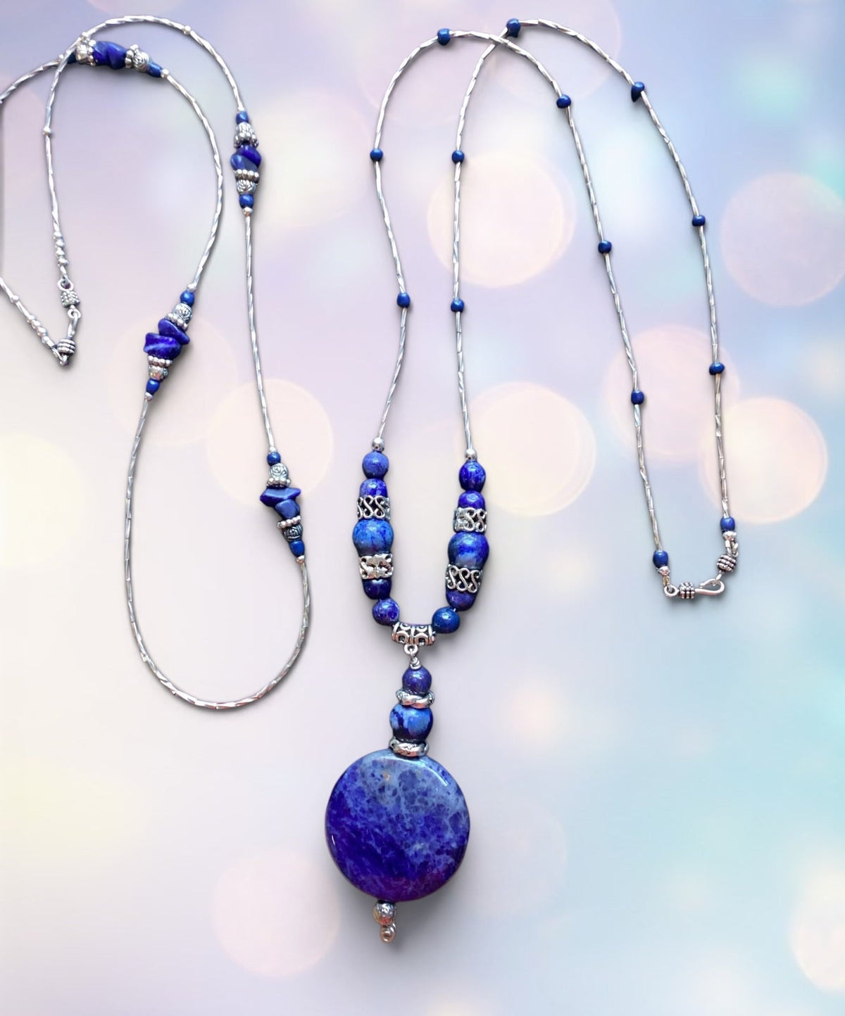 Heartfelt Creations bohemian 
 necklaces, one with a large circular blue Lapis Lazuli pendant and silver spacers. The second, perfectly coordinating necklace has lapis stone ships and silver findings, designed to highlight the main pendant on the other piece!