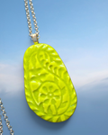 Heartfelt Creations lime green pendant necklace with embossed floral pattern on a silver-toned chain.