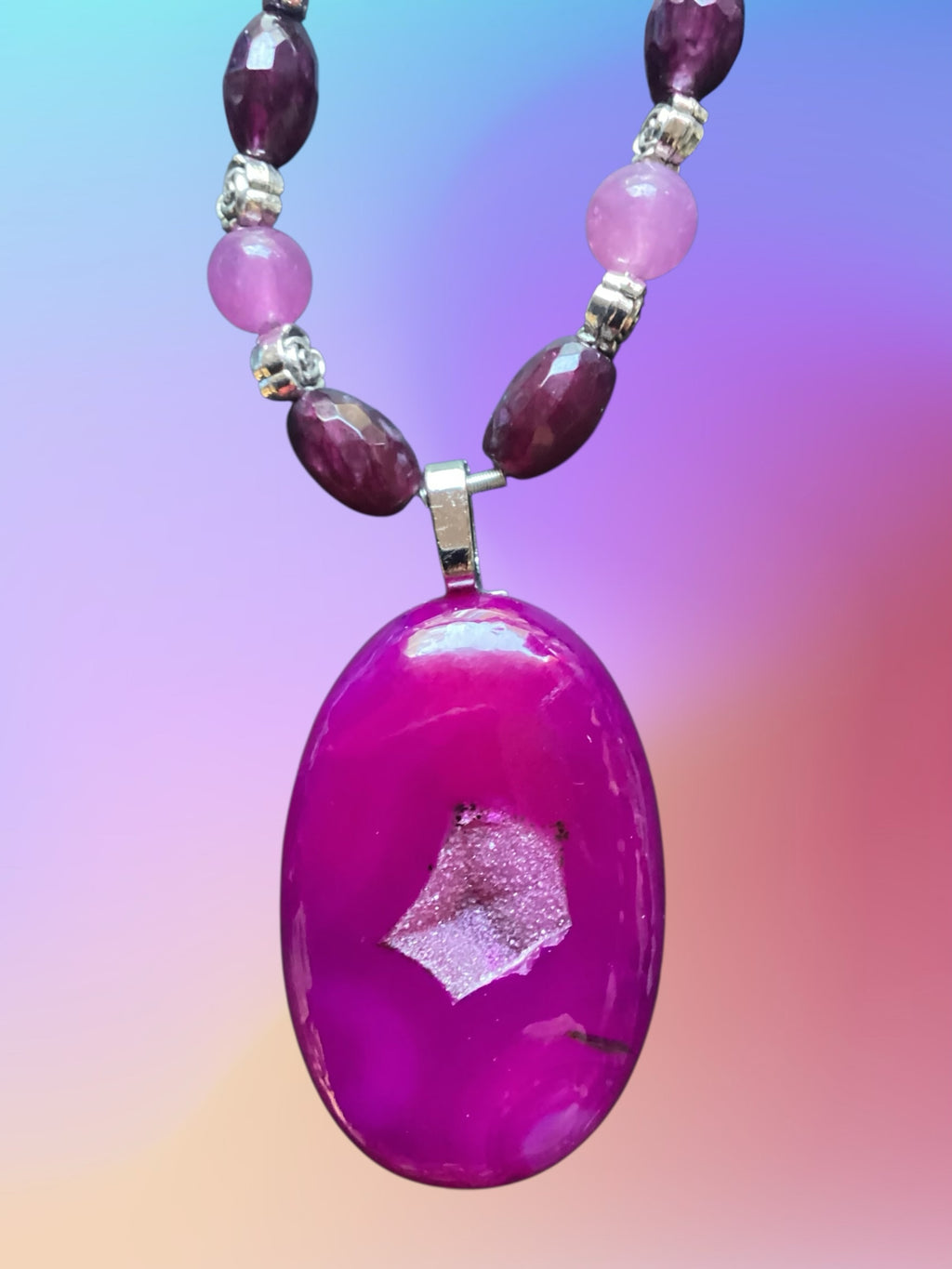 Heartfelt Creations artisan necklace with a polished magenta druzy stone pendant and faceted purple and lavender beads.