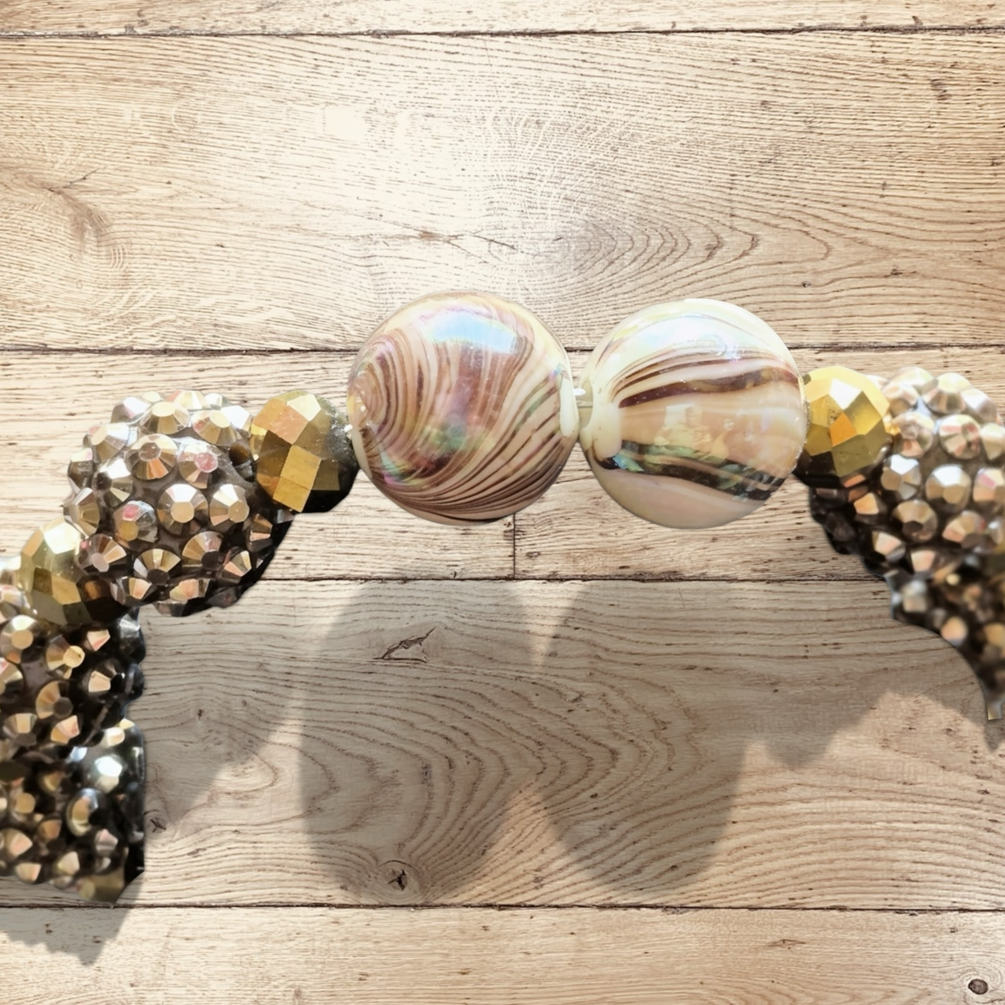 Heartfelt Creations handmade bracelet with large iridescent marbled beads, gold-tone faceted beads, and champagne rondelles.