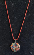 Heartfelt Creations millefiori glass pendant necklace with colorful floral mosaic on a red cord.