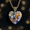 Heartfelt Creations heart-shaped Millefiori glass pendant necklace with colorful floral pattern on blue cord.