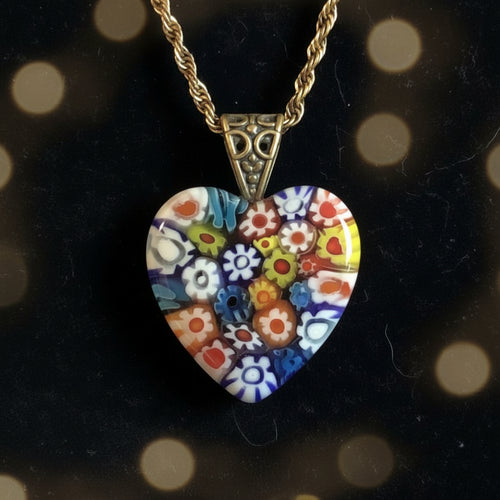 Heartfelt Creations heart-shaped Millefiori glass pendant necklace with colorful floral pattern on blue cord.