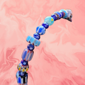 Heartfelt Creations handcrafted bracelet with blue, white, and red Murano glass beads in various shapes and sizes.