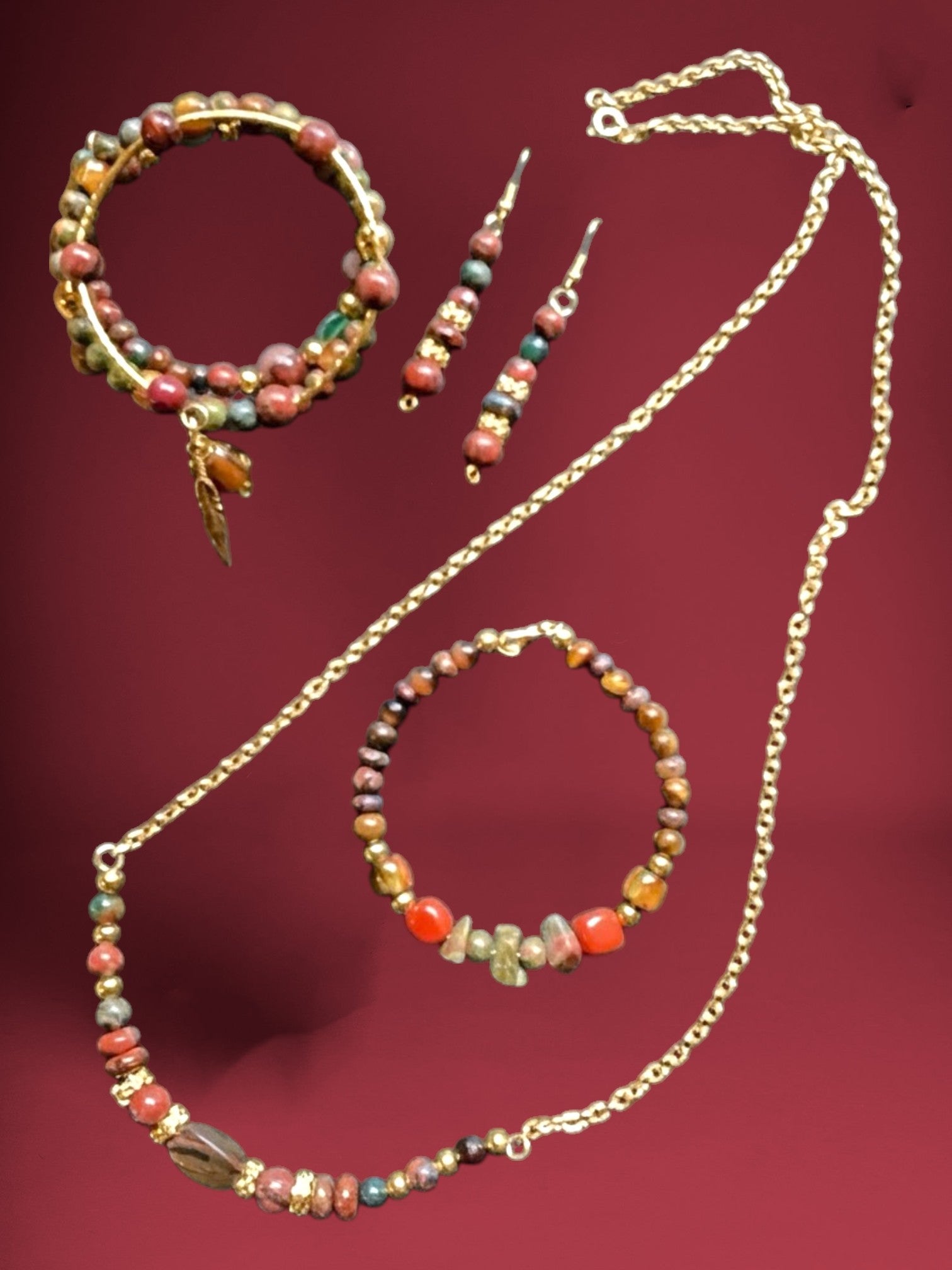 Heartfelt Creations natural stone jewelry set with necklace, bracelet, earrings, and coil bracelet featuring earthy tones and gold accents.