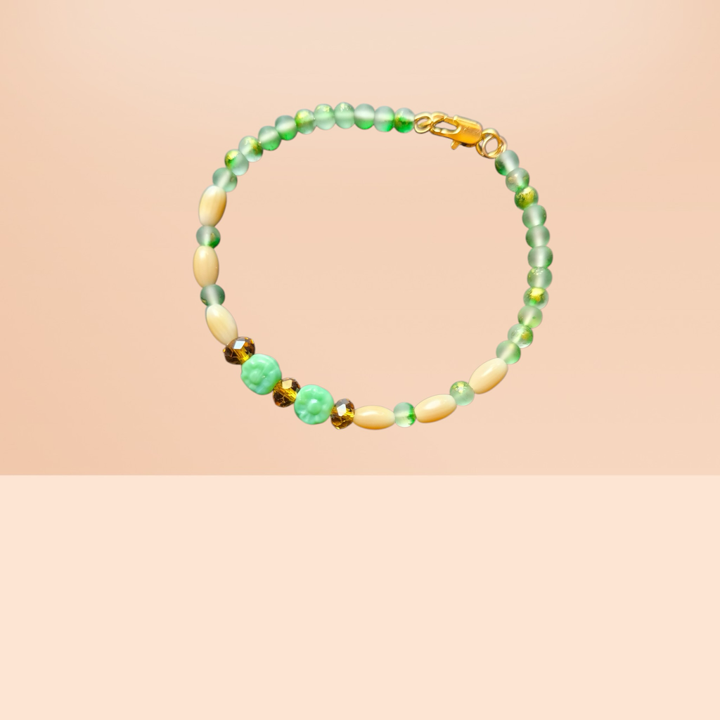 Heartfelt Creations ocean-inspired bracelet with seafoam green beads, shell beads, amber accents, and floral charms.