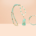 Heartfelt Creations ocean-inspired necklace with seafoam green beads, shell beads, amber accents, and a green stone pendant with quartz.