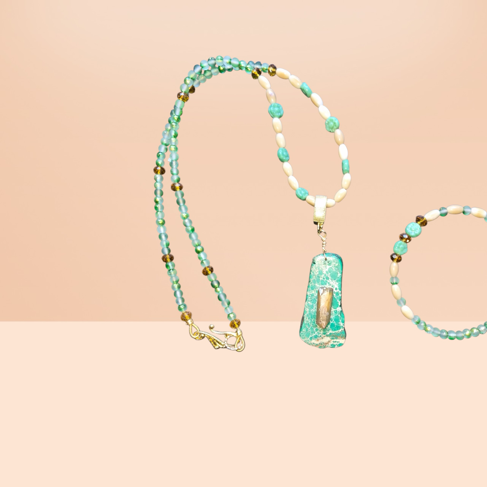 Heartfelt Creations ocean-inspired necklace with seafoam green beads, shell beads, amber accents, and a green stone pendant with quartz.