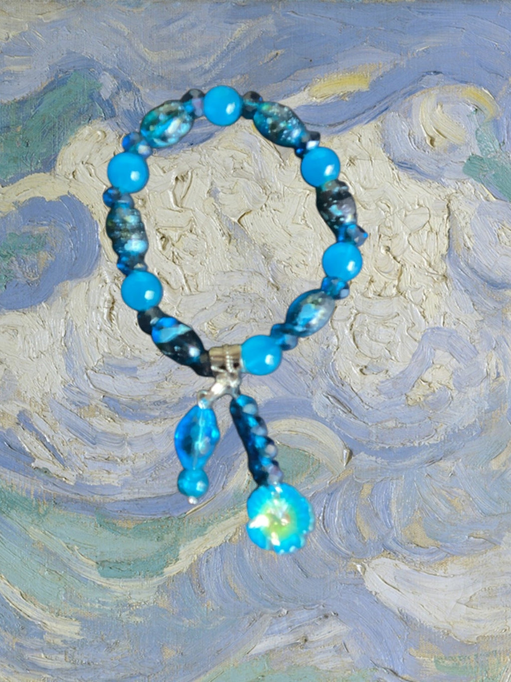 Heartfelt Creations Ocean Breeze beaded bracelet with blue and teal beads, charms, and intricate patterns.