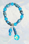 Heartfelt Creations Ocean Breeze beaded bracelet with blue and teal beads, charms, and intricate patterns.
