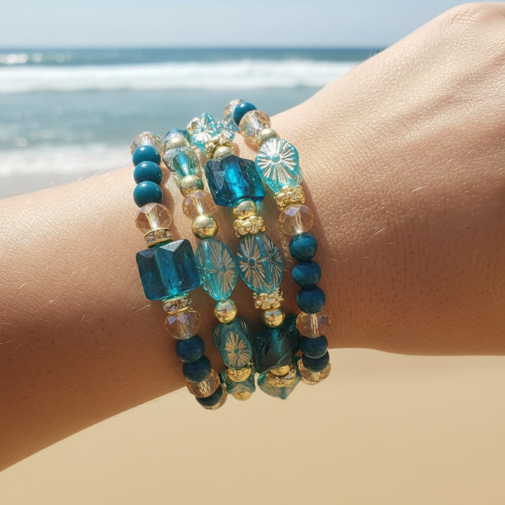 Heartfelt Creations' specialty multi wrap bracelet is a real knockout this time!  Three beaded coils  feature a mix of teal, turquoise, and clear faceted glass beads, interspersed with small gold-toned spacer beads create gorgeous accessory.  This bracelet's oceanic theme will "pop" off your wrist with charm.