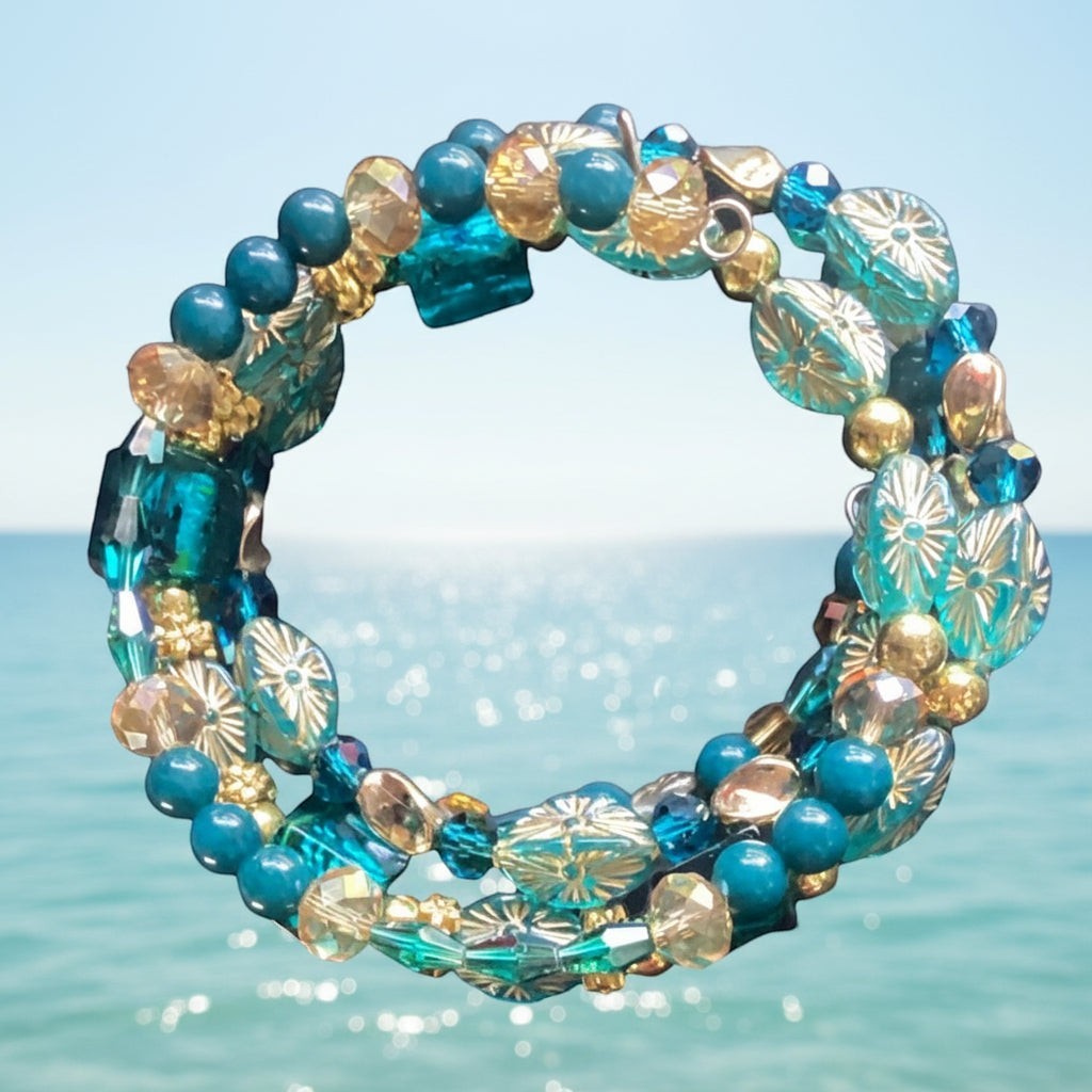 Heartfelt Creations Ocean Jewel beaded bracelet set with teal, gold, and crystal beads, featuring floral glass beads and faceted crystals.