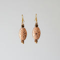 Heartfelt Creations elegant oval embossed dangle earrings with antique brass finish and faceted metallic beads.