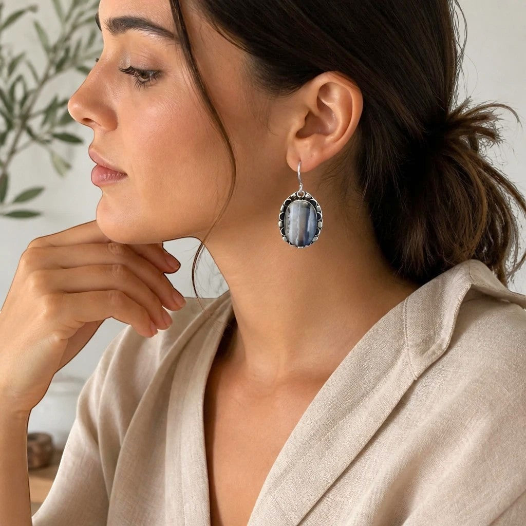 Heartfelt Creations oval drop earrings with a grey and white banded stone in a vintage scalloped metal frame on model