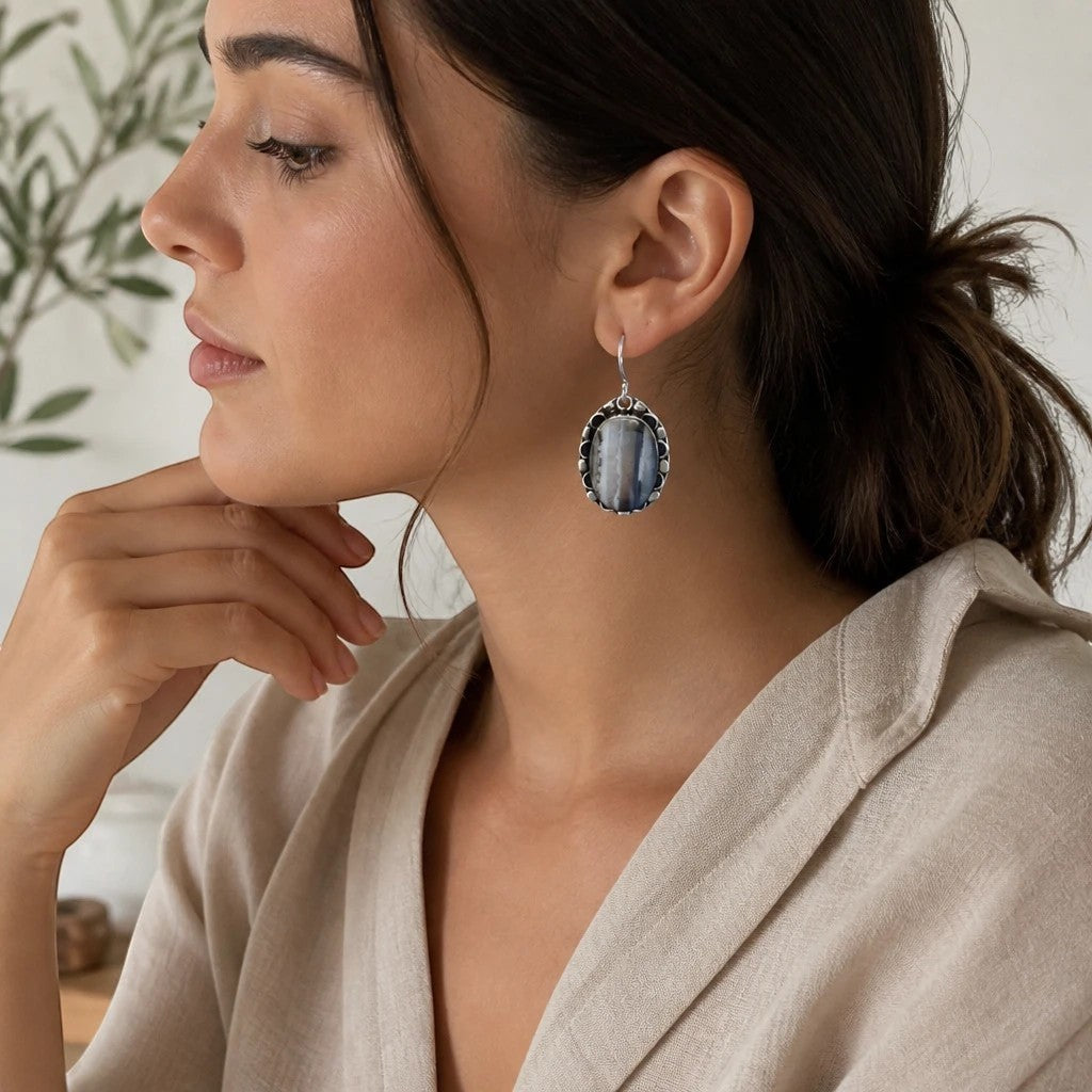 Heartfelt Creations oval drop earrings with a grey and white banded stone in a vintage scalloped metal frame on model