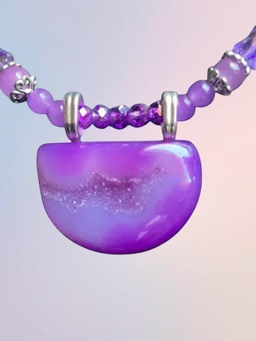 Heartfelt Creations handcrafted purple agate statement necklace with a semi-circular druzy pendant and crystal beads.