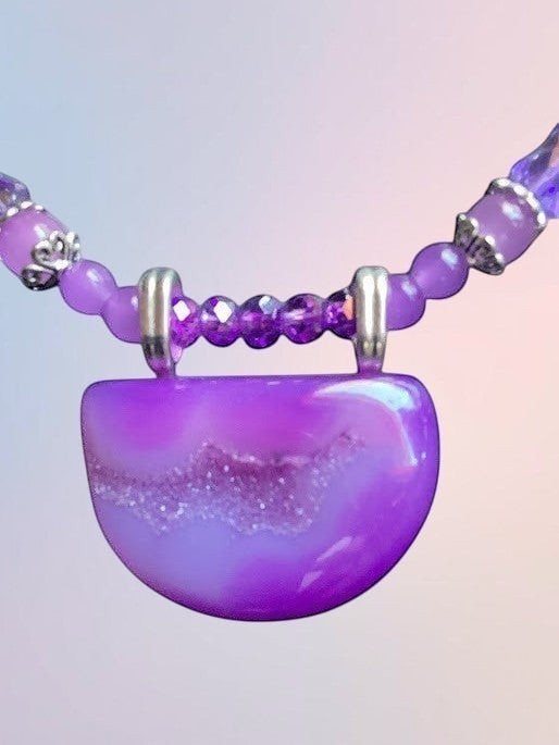 Heartfelt Creations handcrafted purple agate statement necklace with a semi-circular druzy pendant and silver accents.
