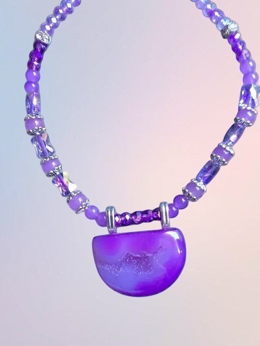 Heartfelt Creations handcrafted purple agate statement necklace with a semi-circular druzy pendant and crystal beads.