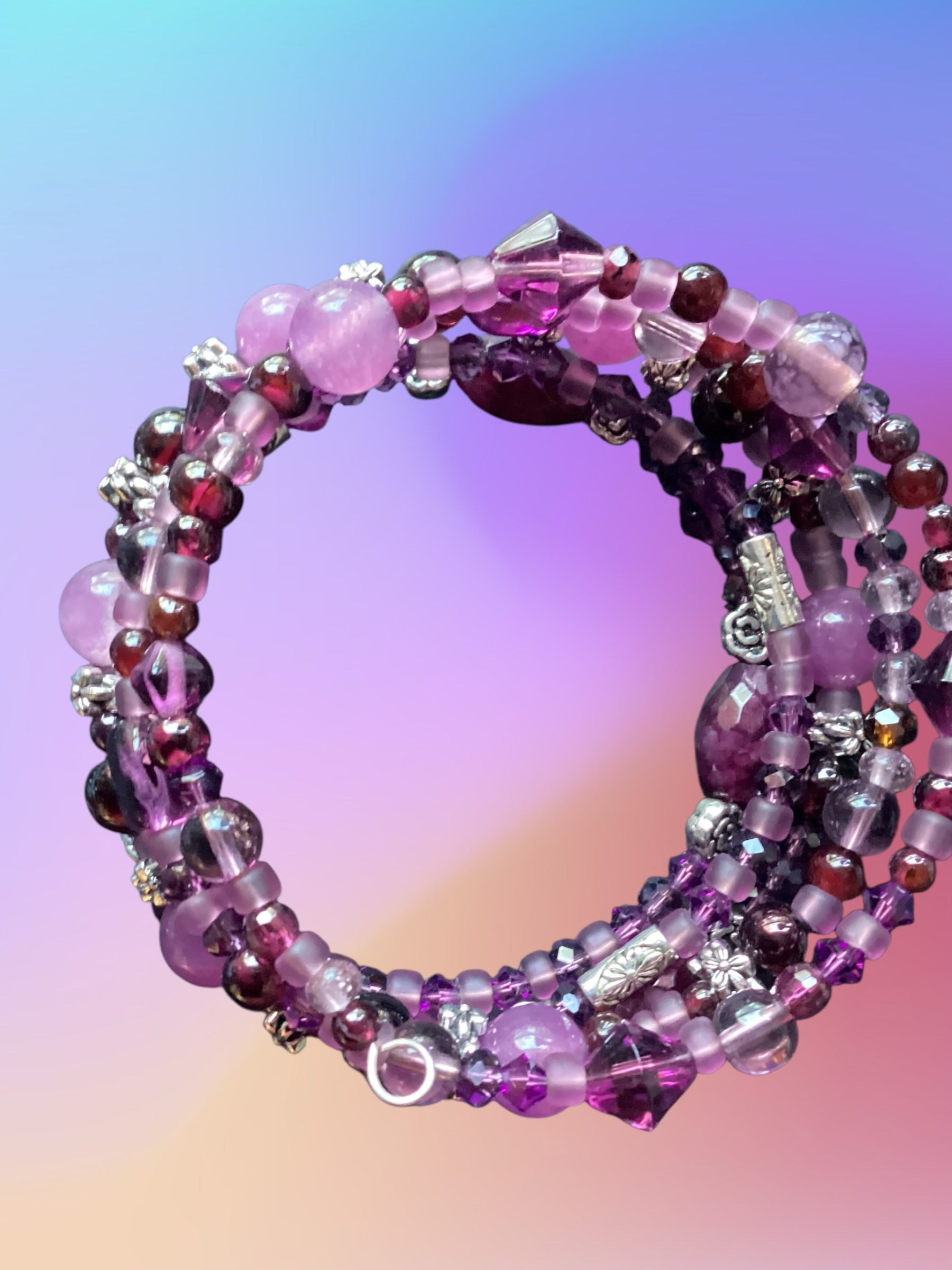 Heartfelt Creations multi-strand beaded bracelet in shades of purple, magenta, and lavender with silver-toned accents.