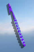 Heartfelt Creations purple metal roach clip featuring faceted crystal-like beads against a blue sky background.