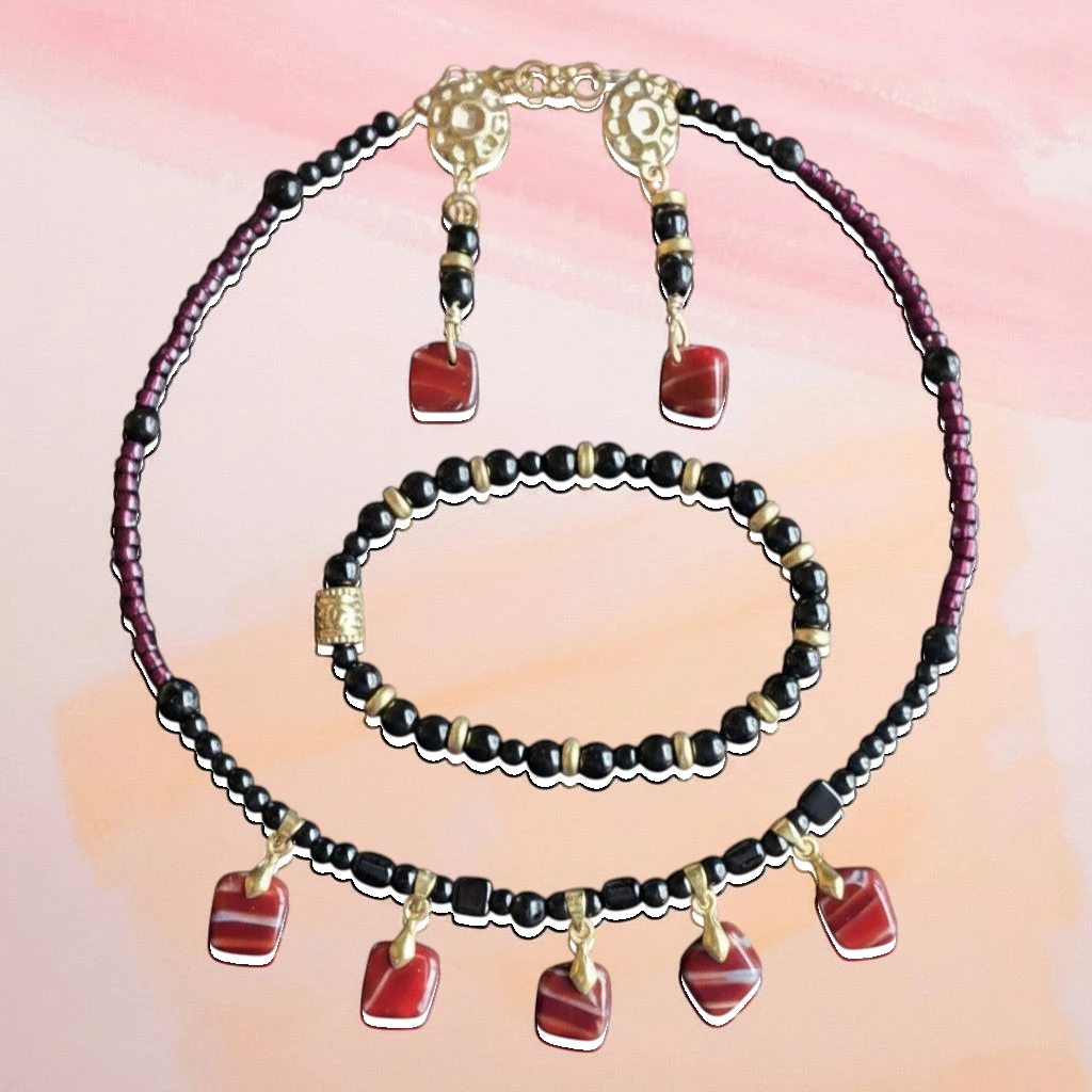 Heartfelt Creations beaded jewelry set with red and black stones, gold-tone accents, necklace, bracelet, and earrings.