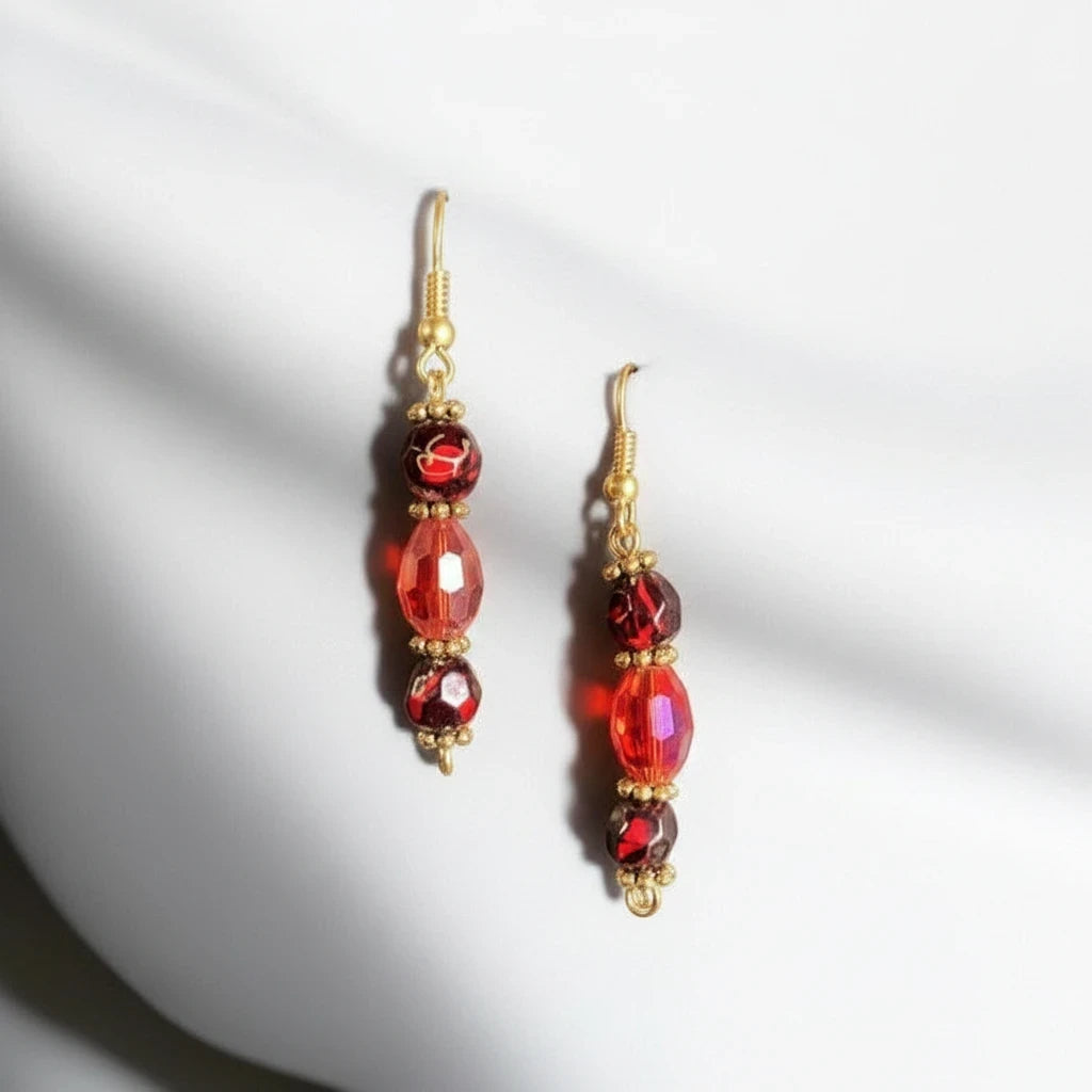 Heartfelt Creations red crystal beaded drop earrings with gold-tone accents and hook backings on a white background.