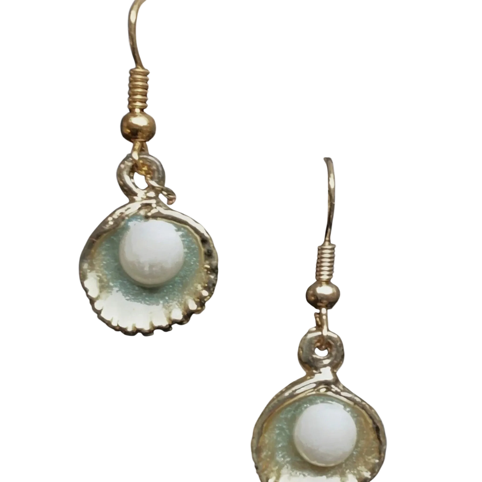 A pair of gold-toned dangle earrings featuring a scallop-shaped shell with a glossy iridescent green and white glaze, hanging from gold fishhook wires against a plain white background.