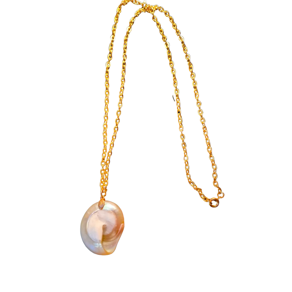 Heartfelt Creations is delighted to offer gold chain necklace featuring a large, organic-shaped pearl pendant from the shores of New Zealand!  It radiates with iridescent white, pink, and green hues, displayed with a golden chain.