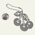 Heartfelt Creations silver-plated brass base metal cherry keychain with a ball-chain attachment shown next to a US quarter coin.