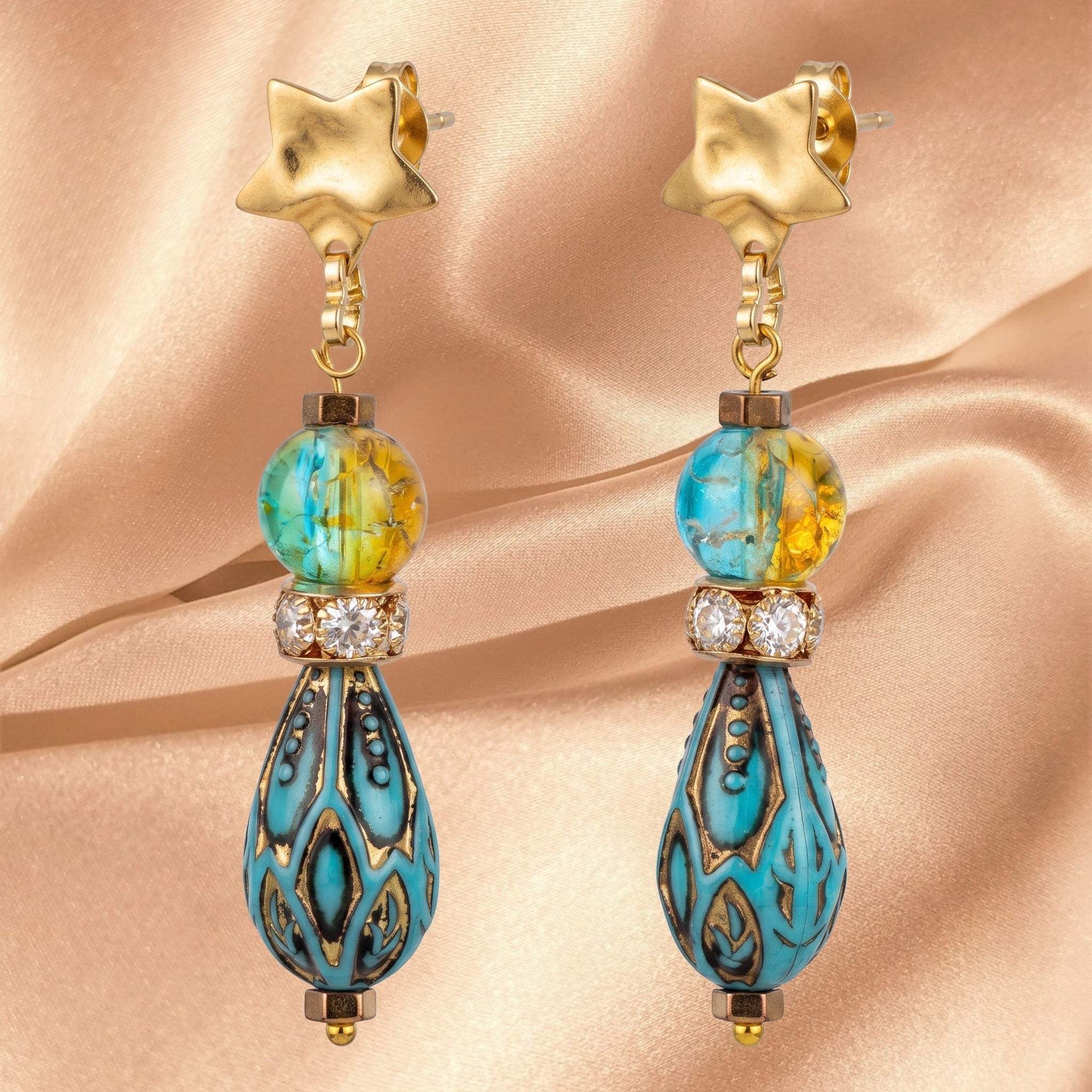 Heartfelt Creations artisan drop earrings with gold star studs, marbled blue-yellow beads, and teal teardrop charms.