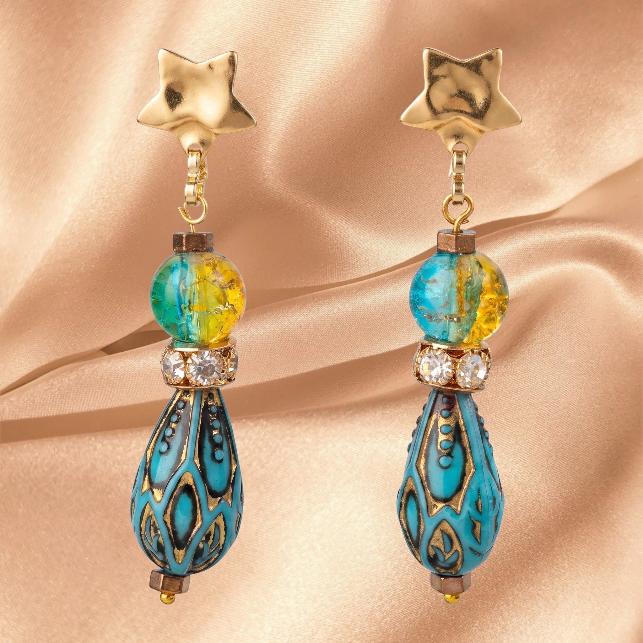 Heartfelt Creations bohemian gold star drop earrings with marbled blue and yellow glass beads and crystal spacers.