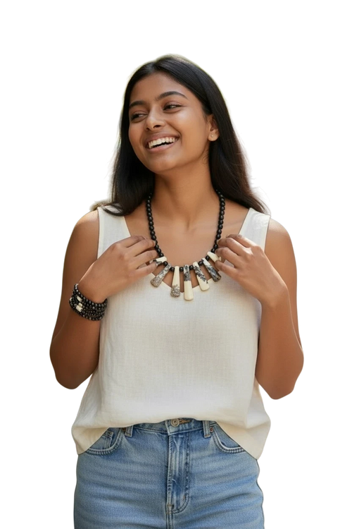 Heartfelt Creations artisan statement necklace and bracelet set with bone-like pendants and black beads on a model