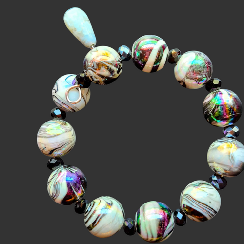 Heartfelt Creations Artisan Beaded Statement Bracelet with swirling white, black, and iridescent beads and a pale blue dangle bead.