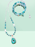 Heartfelt Creations bohemian jewelry set featuring a teal geode pendant necklace and a matching beaded wrap bracelet.