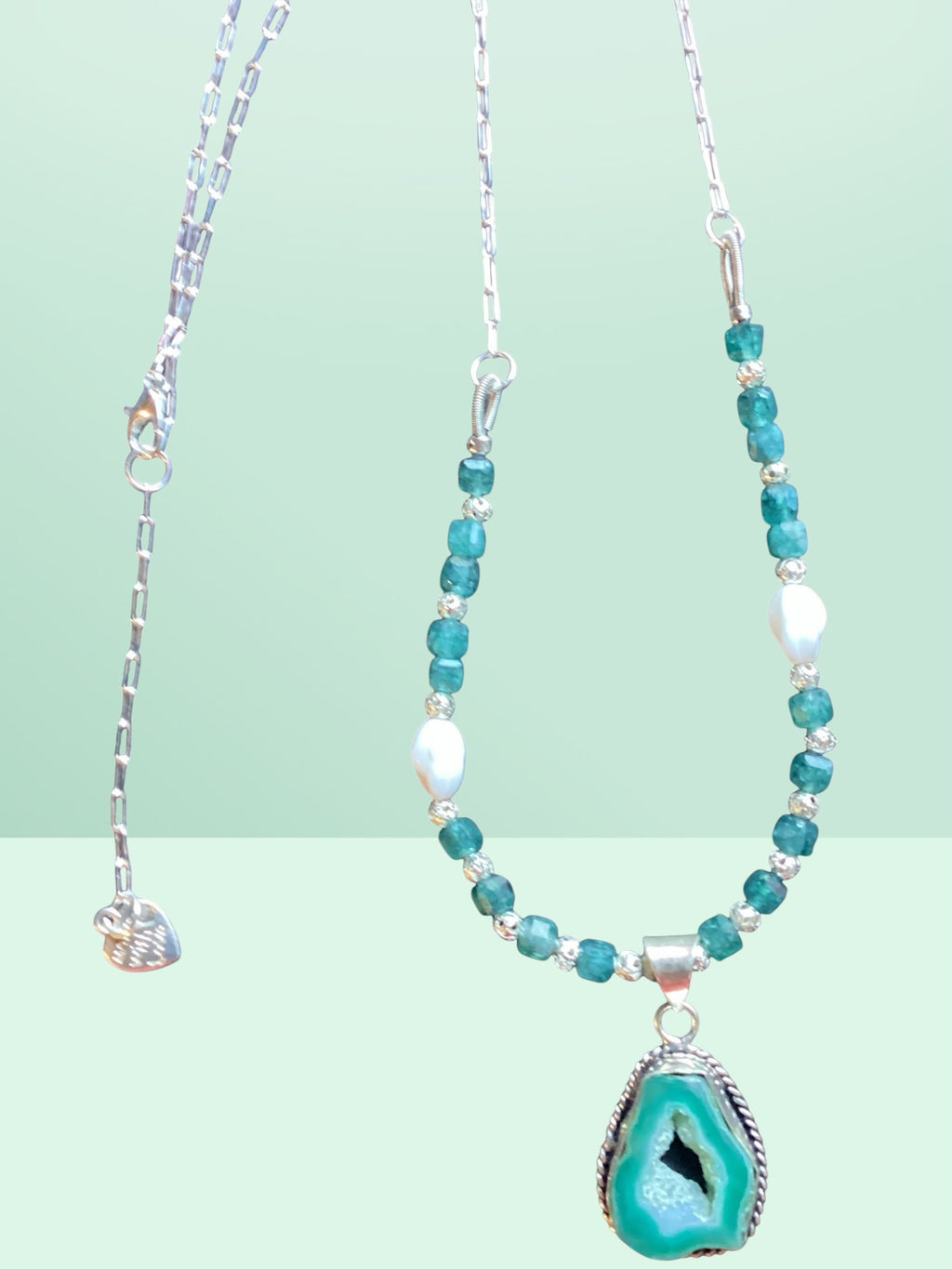 Heartfelt Creations bohemian necklace with teal geode pendant, faceted beads, and silver-tone chain on light background