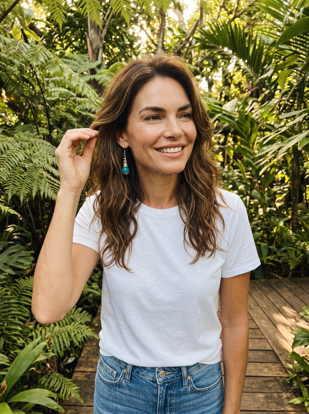 Heartfelt Creations ornate drop earrings with faceted teal stones and antiqued silver scrollwork worn by a smiling woman