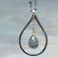 Heartfelt Creations teardrop pendant necklace with faceted labradorite gemstone and gold accents on a chain.