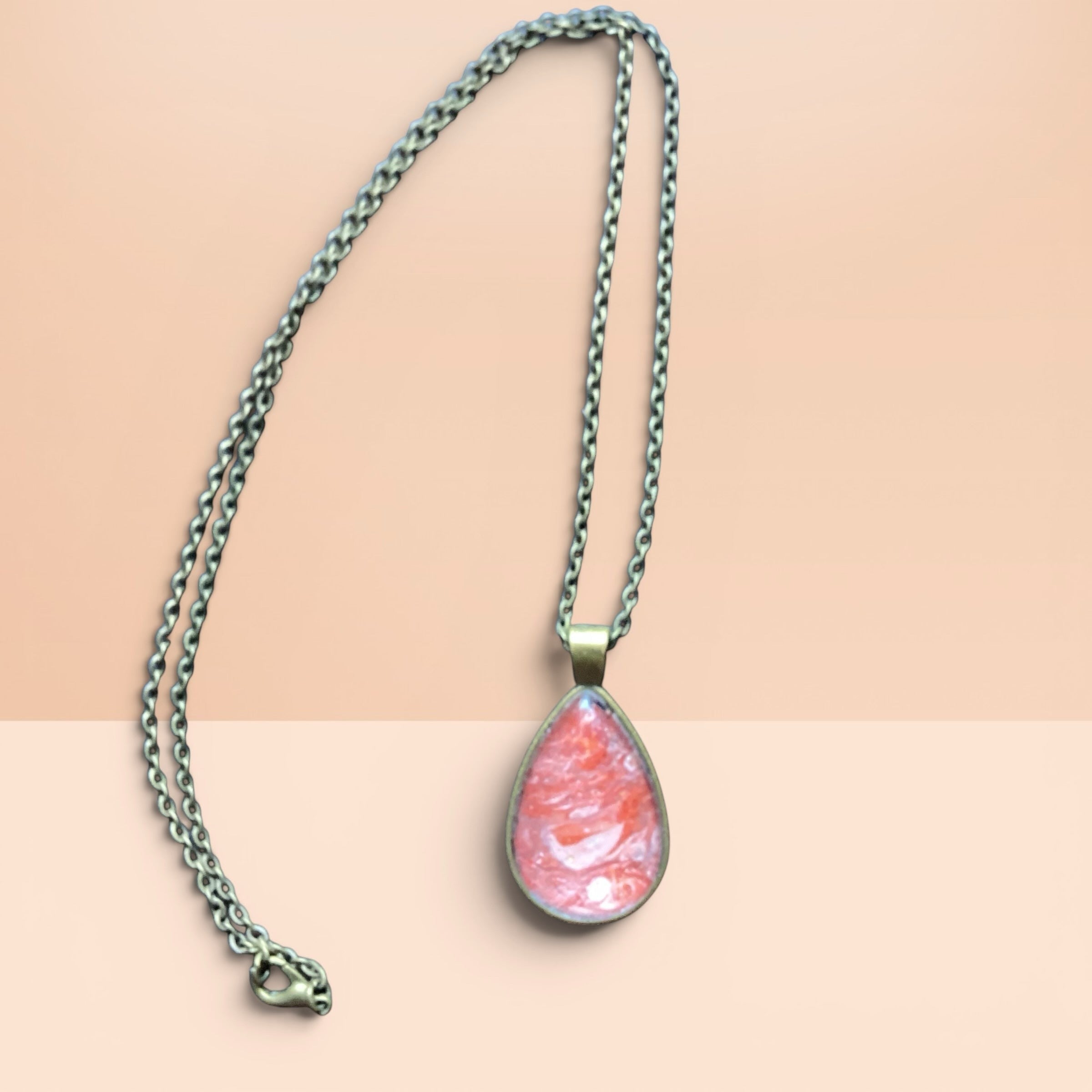 Heartfelt Creations teardrop necklace with a hand-painted coral and peach resin pendant in an antique-bronze setting.