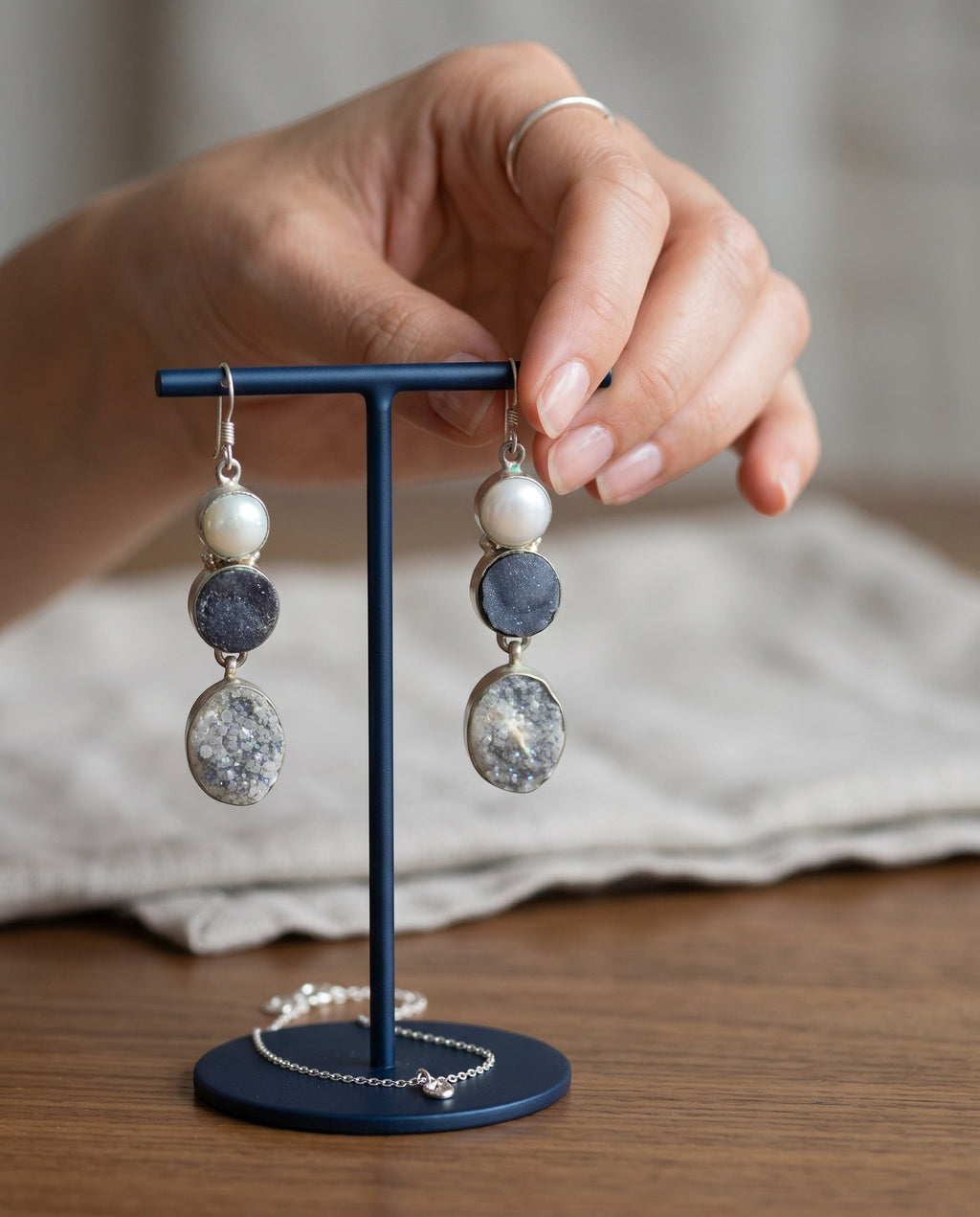 Heartfelt Creations triple drop earrings featuring a white pearl, charcoal druzy, and crystal druzy in sterling silver.