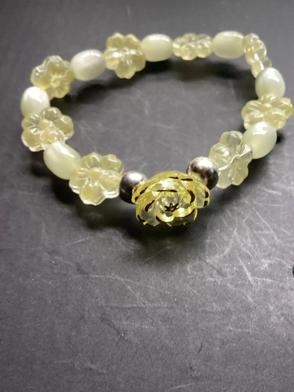 Heartfelt Creations yellow floral charm bracelet with oval beads and a golden rose charm.