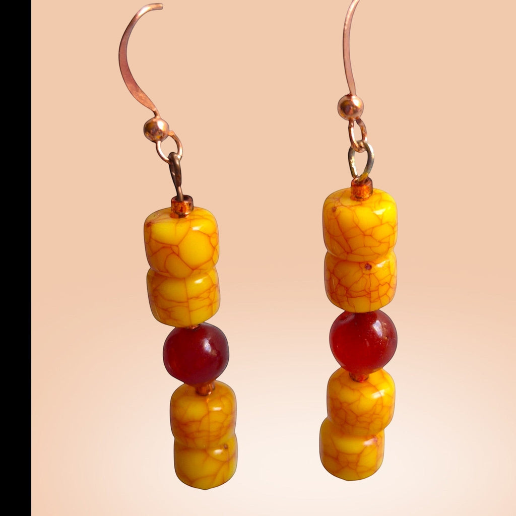 Heartfelt Creations drop earrings featuring yellow crackle-textured beads and translucent red accent beads on hooks.