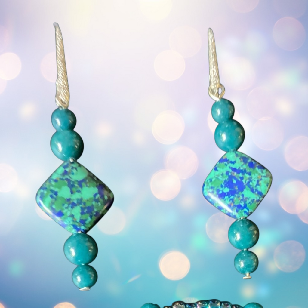 Pair of turquoise beaded earrings with a blurred light background