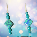 Pair of turquoise beaded earrings with a blurred light background