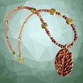 Necklace with red beads and a decorative pendant on a geometric green background